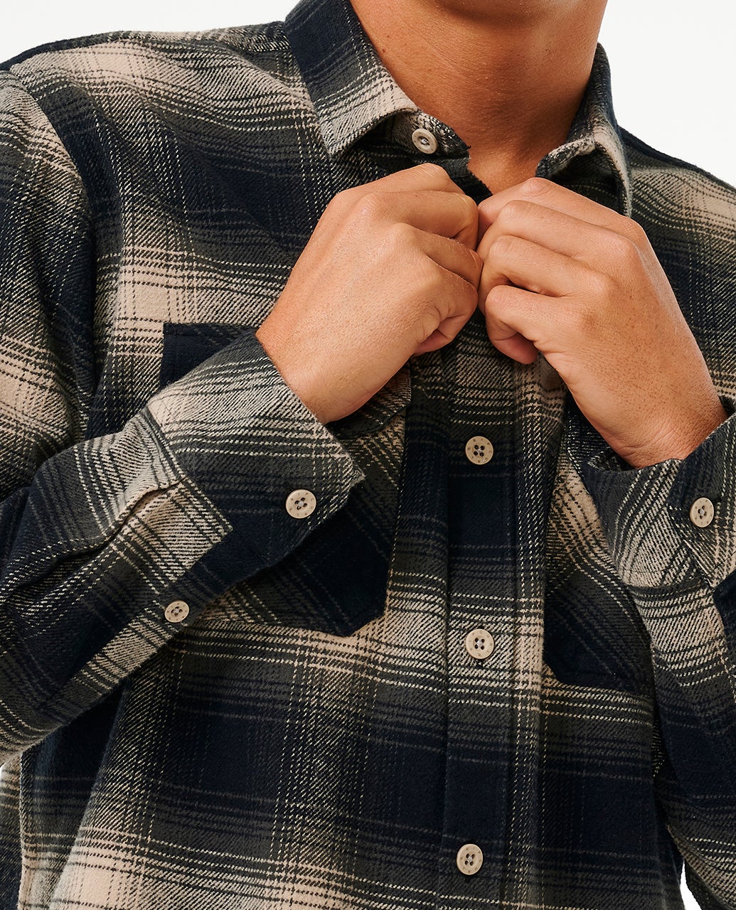 Man buttoning up the Rip Curl Classic Surf Count Flannel Shirt