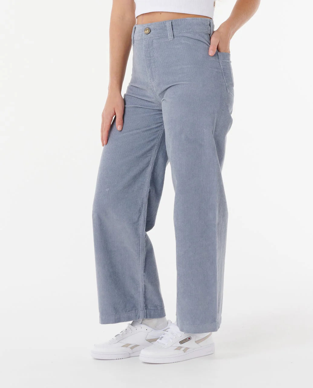 a woman wearing the rip curl stevie cord trousers
