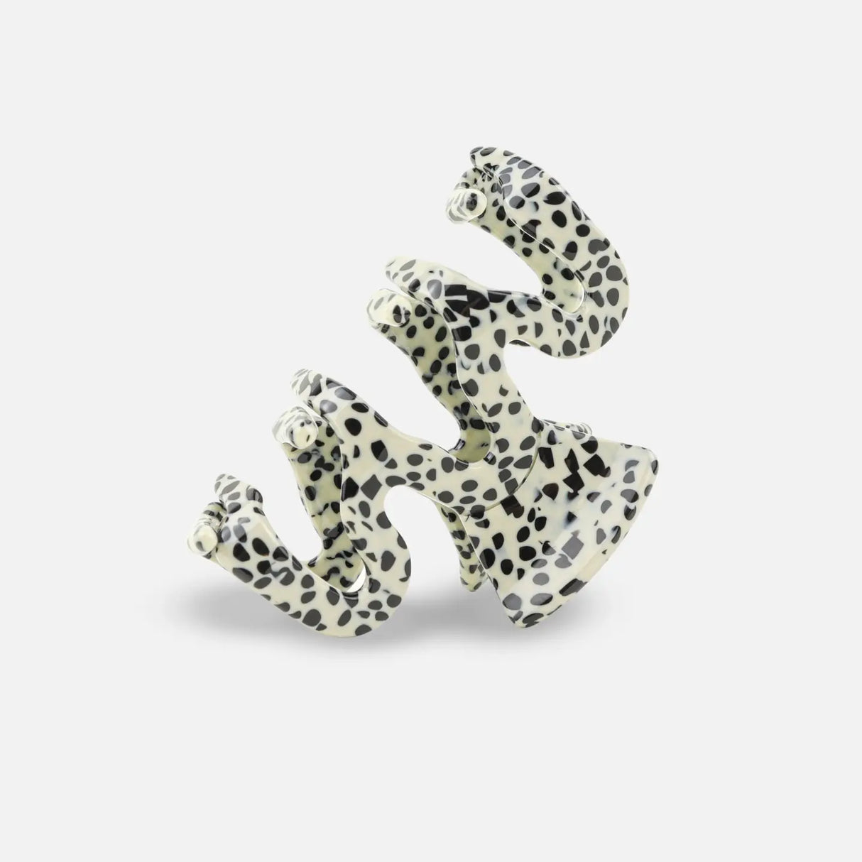 Polka dot sasstie hair clip on a white background