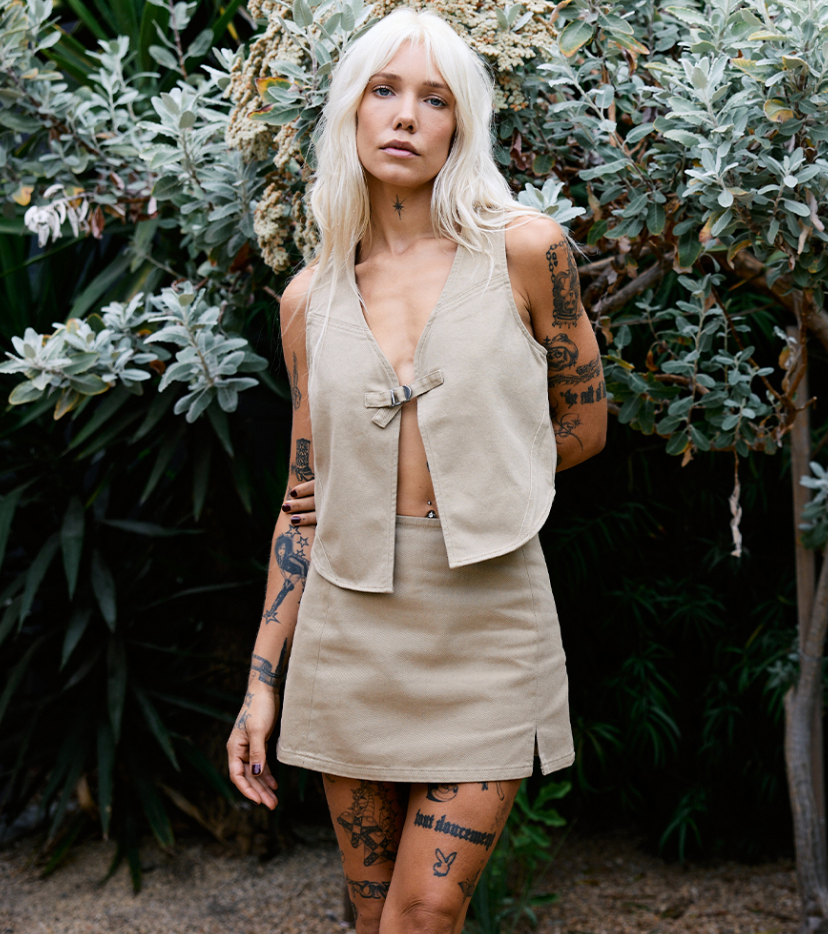 a woman with platinum blonde hair wearing a rvca outfit