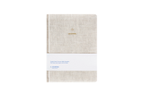 Beige linen hard cover journal on a white background