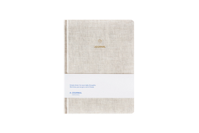Beige linen hard cover journal on a white background
