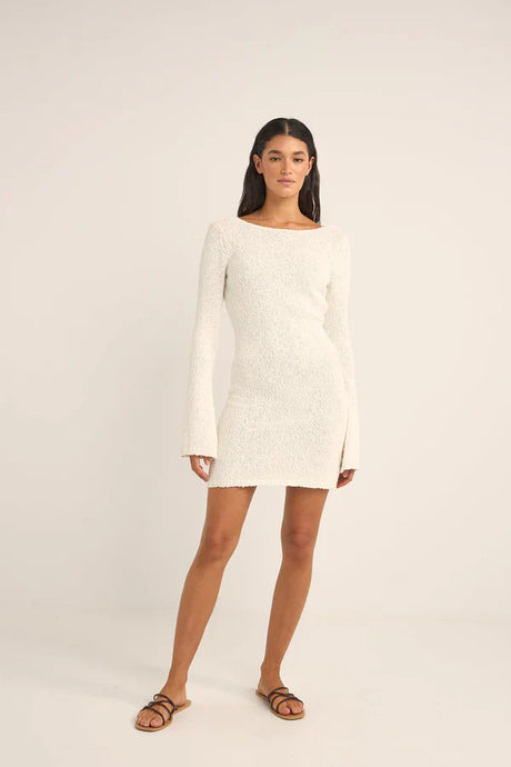 Woman wearing the rhythm adele long sleeve knit dress against a white background