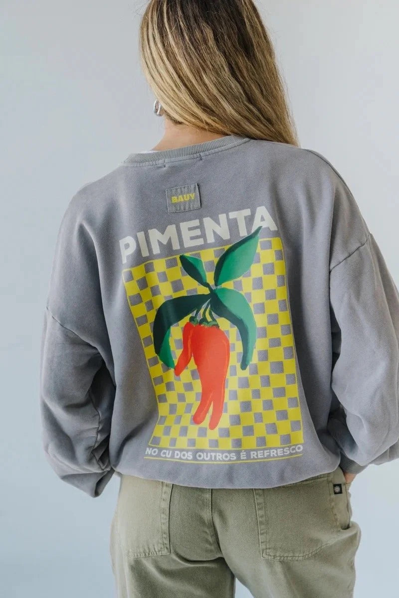 Person wearing a gray bauy peppet sweatshirt with a colorful graphic and text on the back.