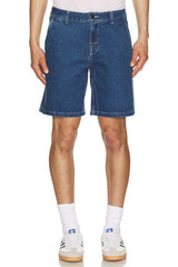 Person wearing dark wash rhythm denim shorts on a white background