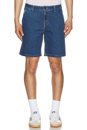Person wearing dark wash rhythm denim shorts on a white background