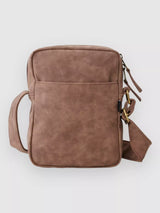 Rip Curl Brown leather crossbody bag on a light gray background