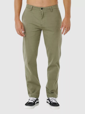 Man wearing rip curl classic surf chino cactus green pants on a white background