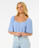 woman wearing a rip curl san carlos button top and jeans against a white background