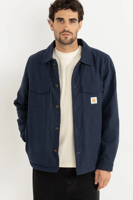 Man wearing an unbuttoned rhythm sherpa lined workshirt in blue
