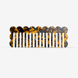 Tortoiseshell-patterned hair comb on a white background