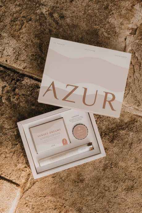 Unwind bath gift set with 'AZUR' branding on a stone surface with bath salts and natural body soap