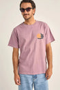 a man wearing a rhythm tropic radio vintage t-shirt in grape colour