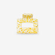 Yellow textured square sasstie hair clip on a white background