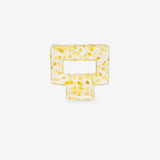 Yellow square-shaped hair clip on a white background